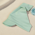 Mint green headscarf on knitted fabric with light blue flower