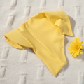 Yellow baby headscarf on knitted fabric with yellow flower